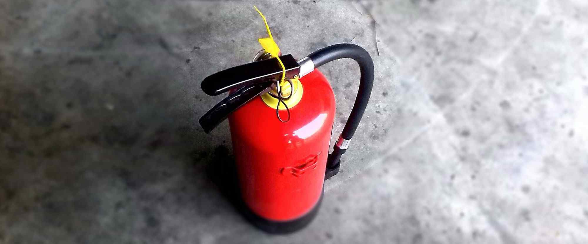 A fire extinguisher reminds that a telephone answering service helps the system in your business