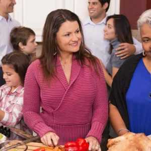 Family members cooking together during a stress-free holiday season thanks to an answering service