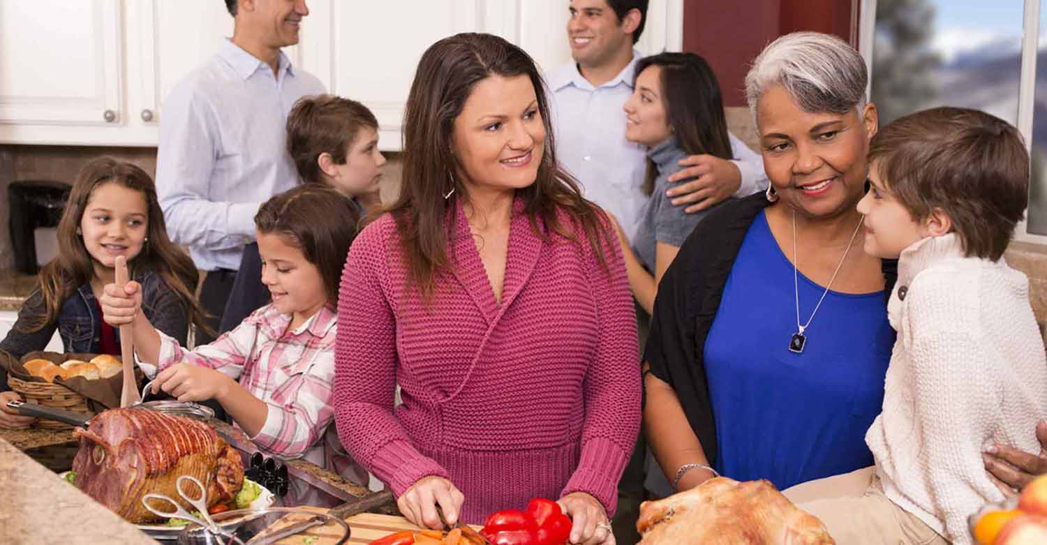 Family members cooking together during a stress-free holiday season thanks to an answering service
