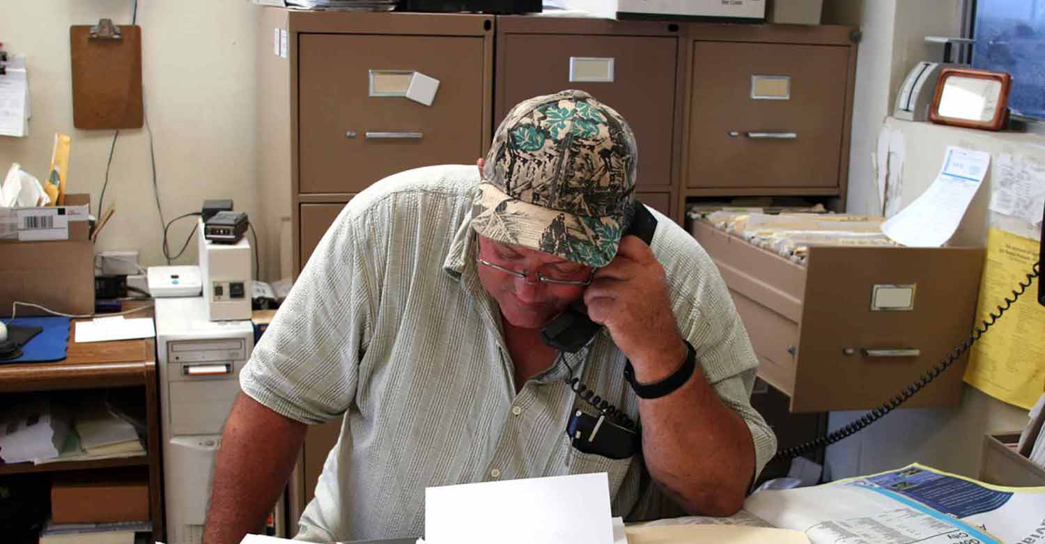 An HVAC expert on the phone with a client while Centratel’s HVAC Answering Service manages all calls