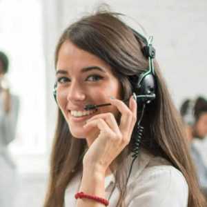 A Centratel Telephone Answering Service operator smiling and speaking to a client