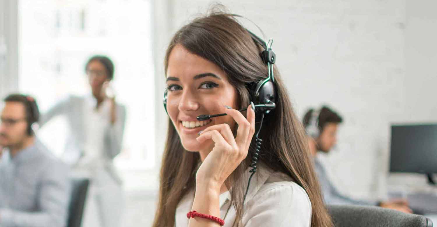 A Centratel Telephone Answering Service operator smiling and speaking to a client