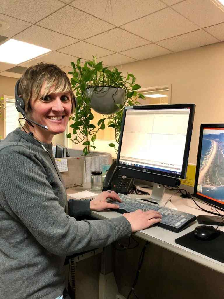 Senior Telephone Service Representative Jenna working at her desk