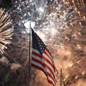 The American flag with fireworks on July, 4th while your calls are covered by an answering service