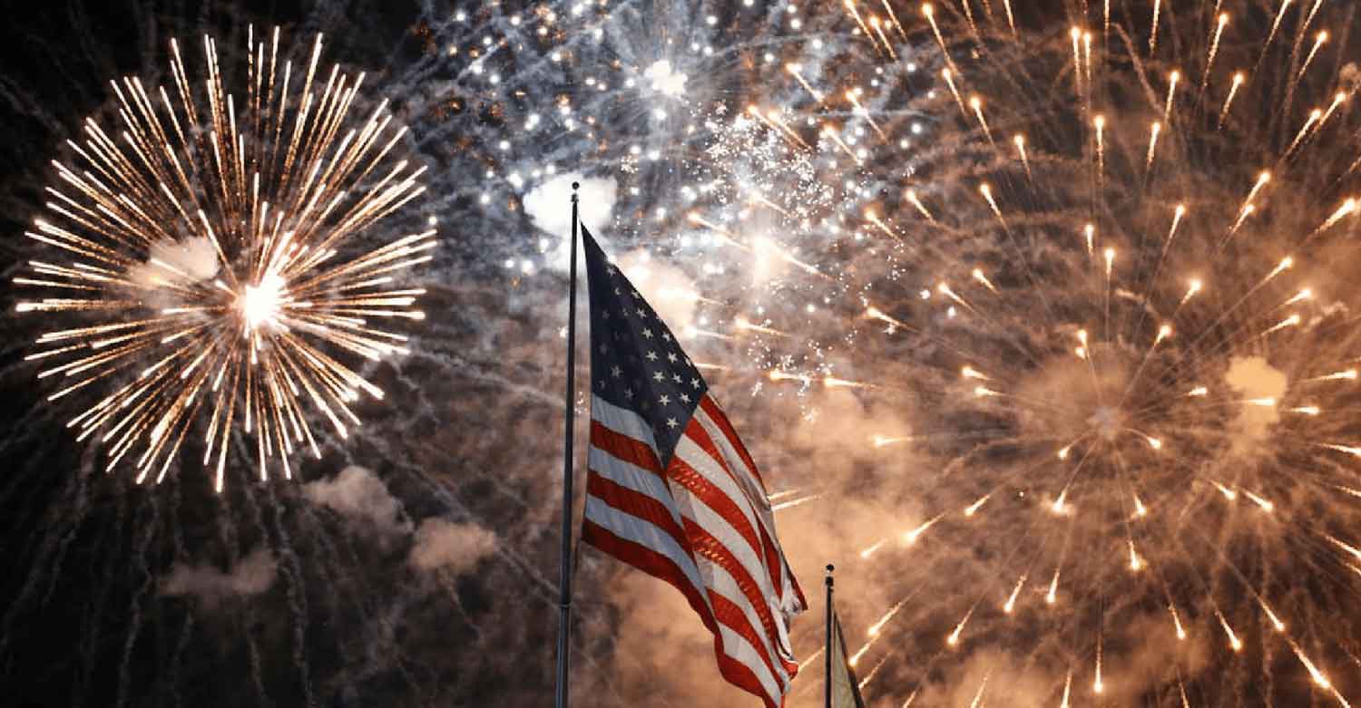 The American flag with fireworks on July, 4th while your calls are covered by an answering service