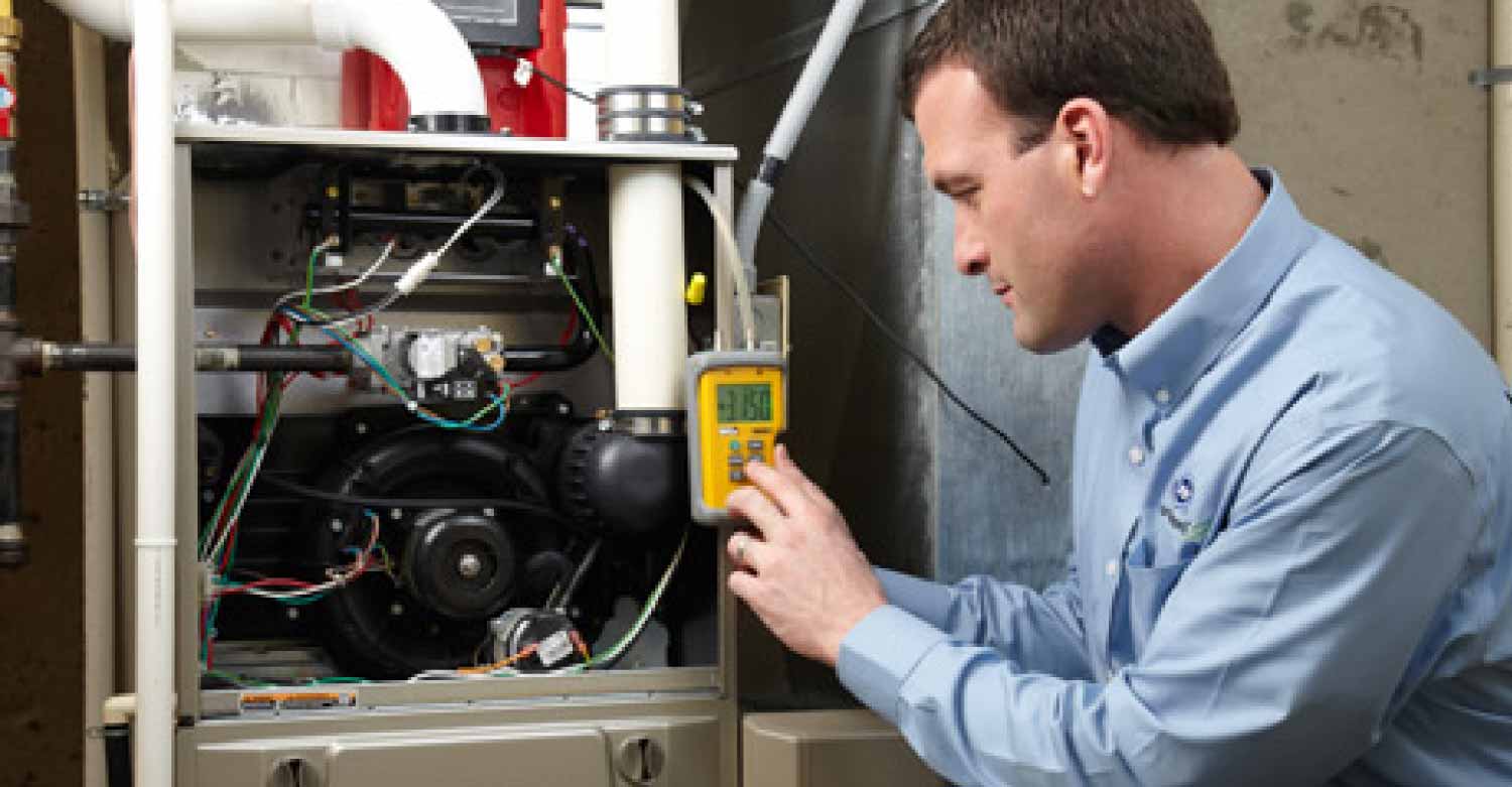 Heating and ventilation technician working after an emergency call from his HVAC answering service