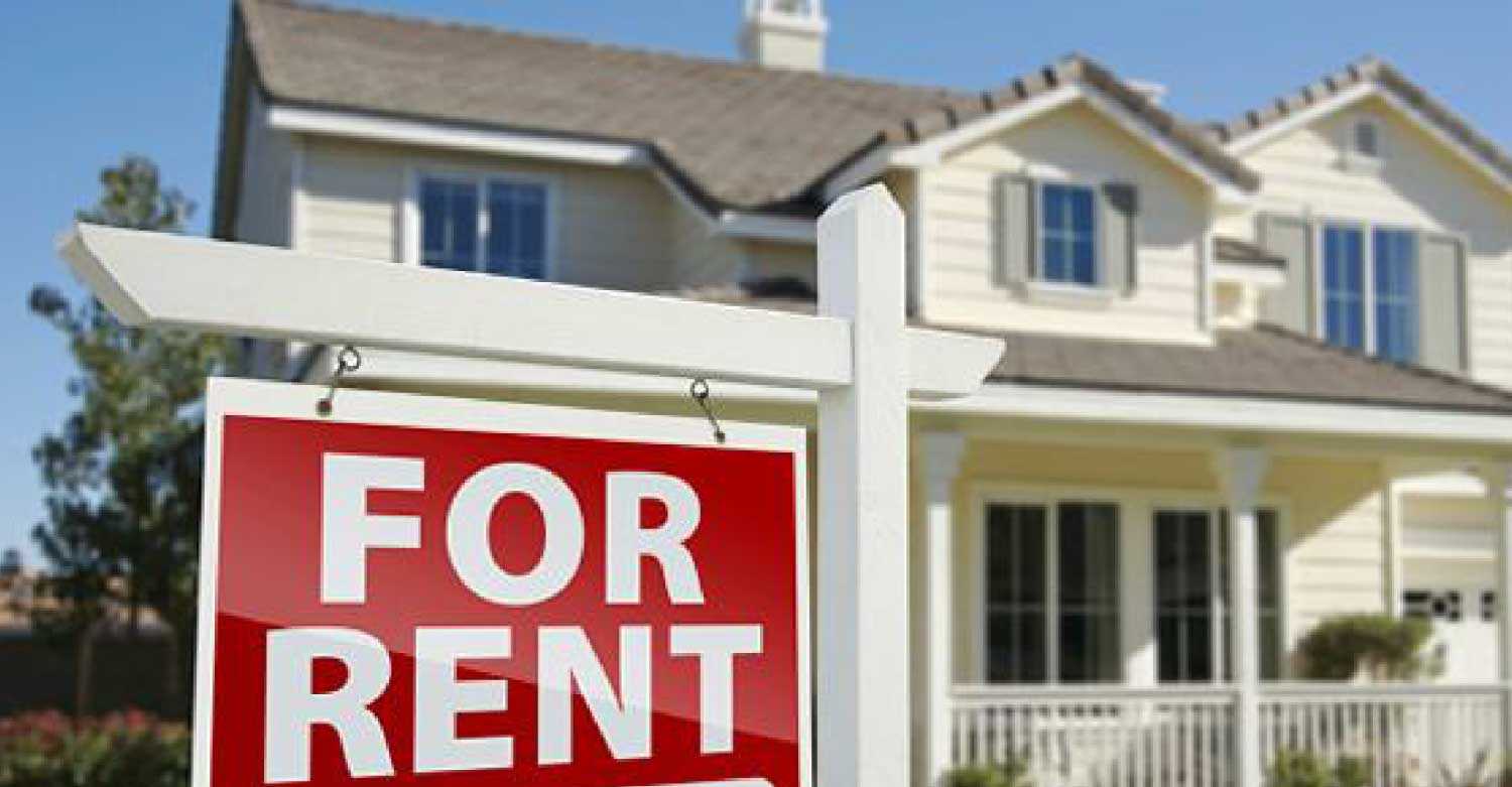 A For Rent sign in front of a house placed by a property manager preparing for the new year