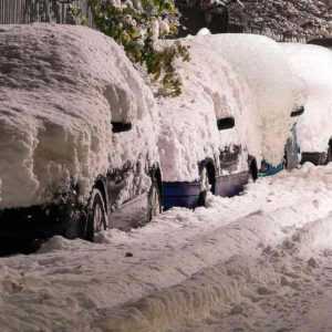 Old man stuck in a car in the middle of a snowstorm calling a health care answering service for help