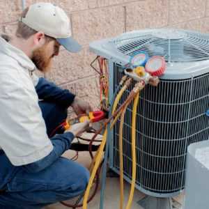An HVAC expert working to repair an Air Conditioning and Refrigeration system
