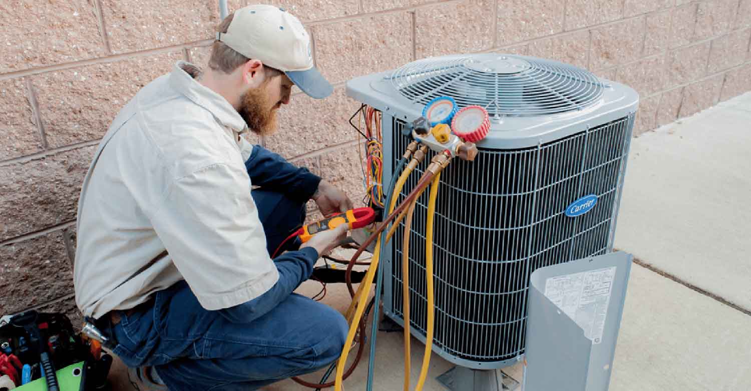 An HVAC expert working to repair an Air Conditioning and Refrigeration system