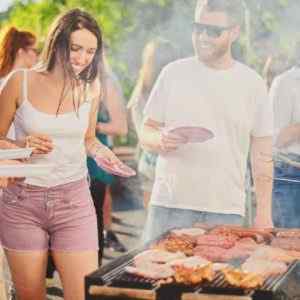 People having fun at a barbeque enjoying the benefits of using an answering service on memorial day