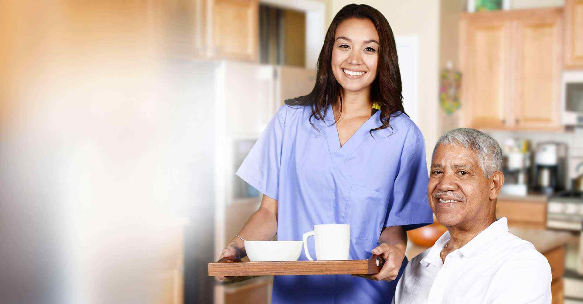 Home Care nurse helping an old man while her calls have been taken by a telephone answering service