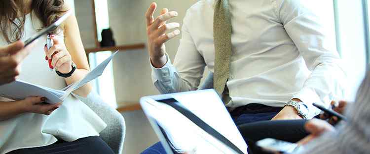 Centratel Telephone Answering Service's employees talking and discussing during a training session