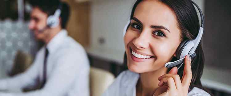 Telephone Service Representative smiling answering calls at Centratel Telephone Answering Service
