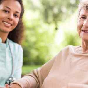 Home Care nurse assisting a woman knowing that calls will be taken by a telephone answering service