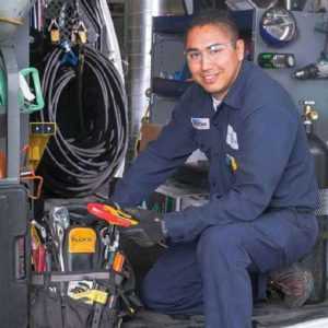 HVAC worker assessing the condition of his tools knowing that an answering service will help