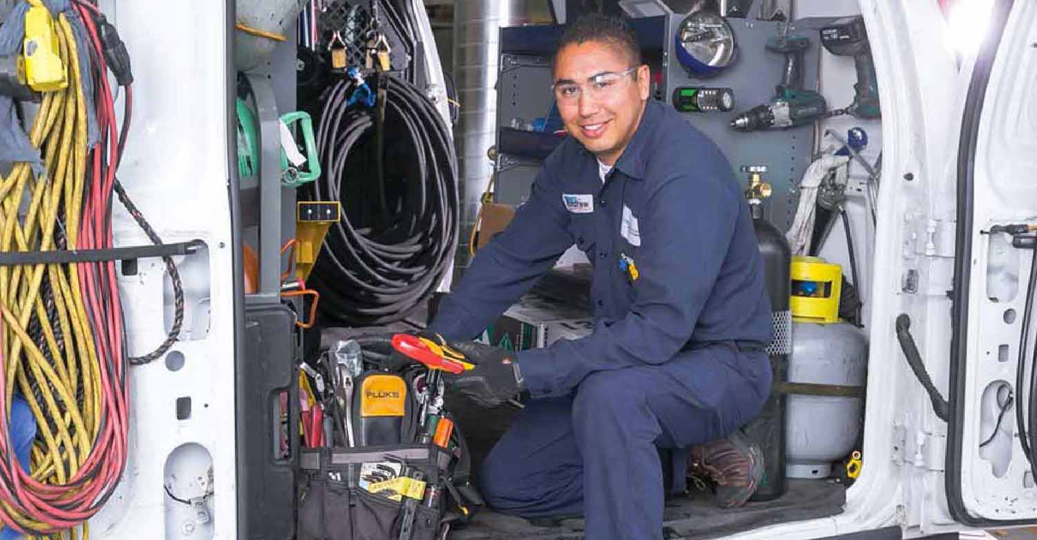 HVAC worker assessing the condition of his tools knowing that an answering service will help