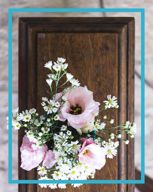 A flower bouquet on a coffin arranged by Centratel's funeral home client