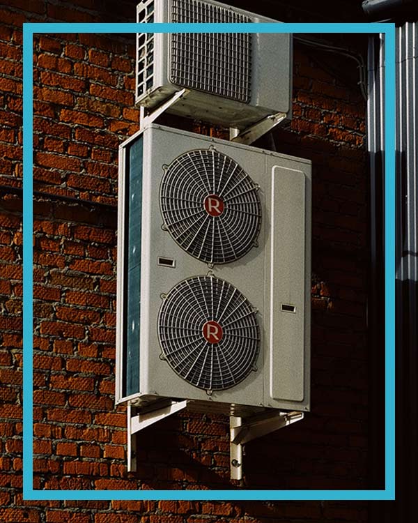 Air conditioner units installed on a red brick wall by a Centratel's client HVAC contractor