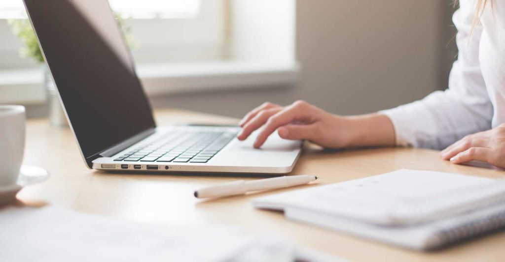 A girl working at her computer knowing that calls will be taken from an answering service