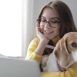 A girl and her pet during the telehealth visit with the veterinarian