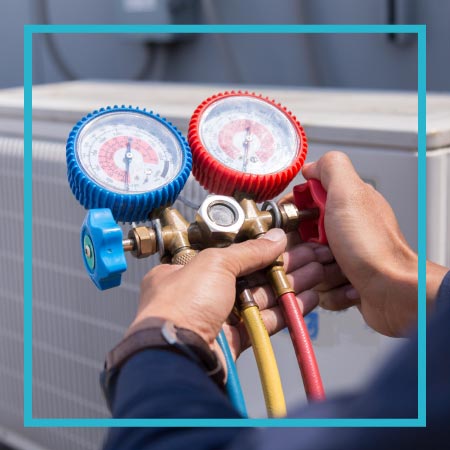 A technician holding tools while a Telephone Answering Service takes care of his HVAC business