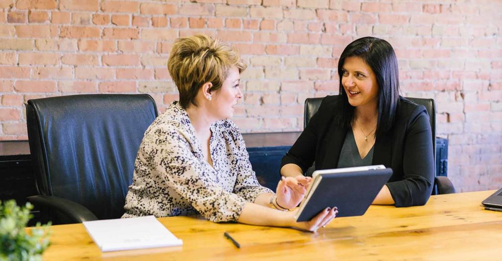 A property manager having a positive discussion with her tenant