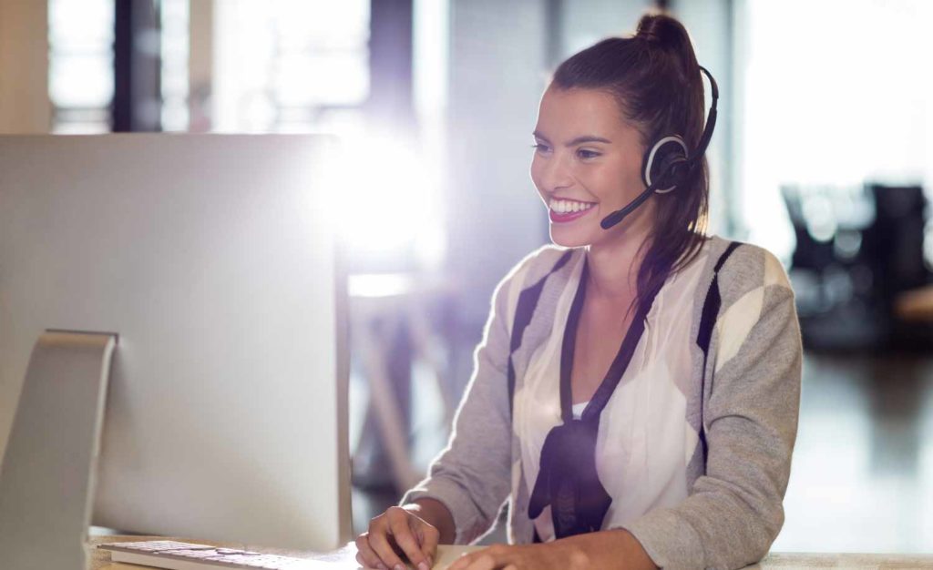 A Telephone Answering Service operator smiling while helping the Property Manager