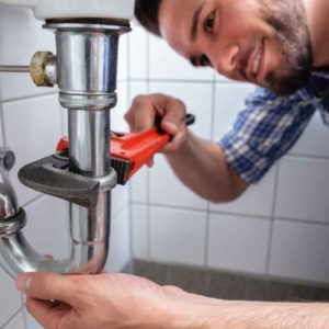 A plumber working with peace of mind for having Centratel Answering Service taking care of his calls