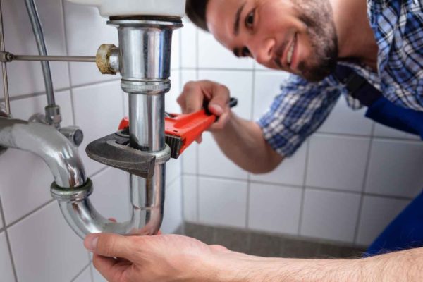 A plumber working with peace of mind for having Centratel Answering Service taking care of his calls