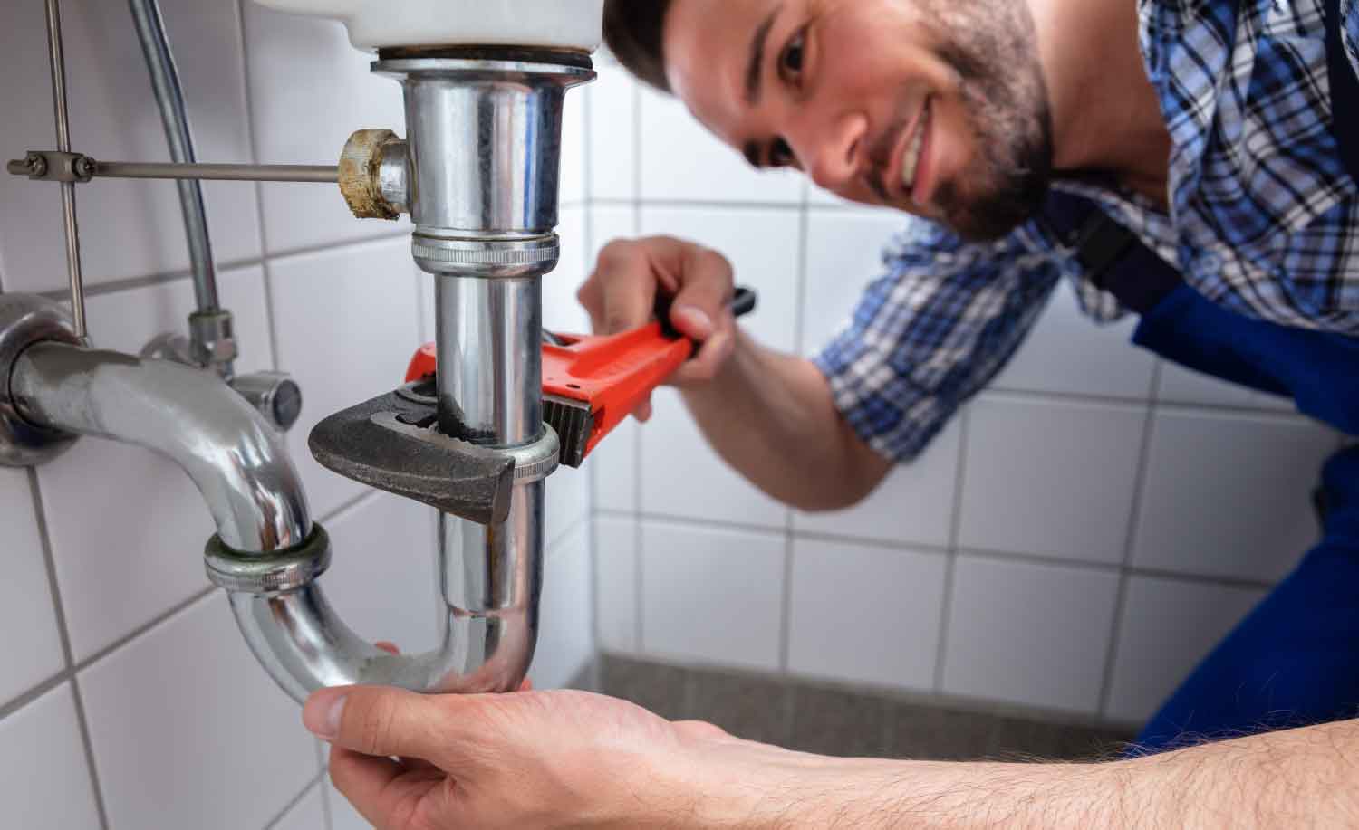 A plumber working with peace of mind for having Centratel Answering Service taking care of his calls