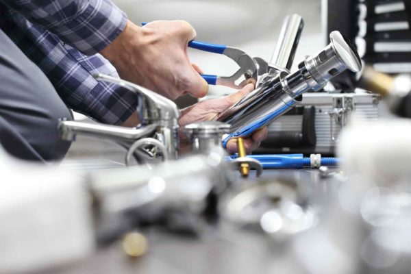 Plumbing business owner while working helped by an HVAC answering service