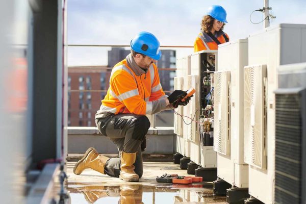A HVAC technician working while Centratel Telephone Answering Service handles his client's calls