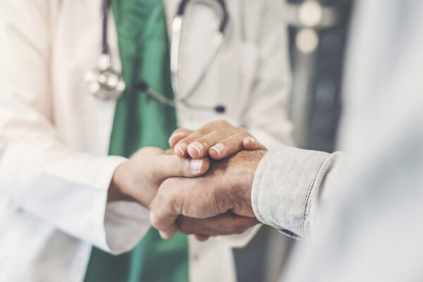 A home health care doctor shaking hands and providing the perfect partnership