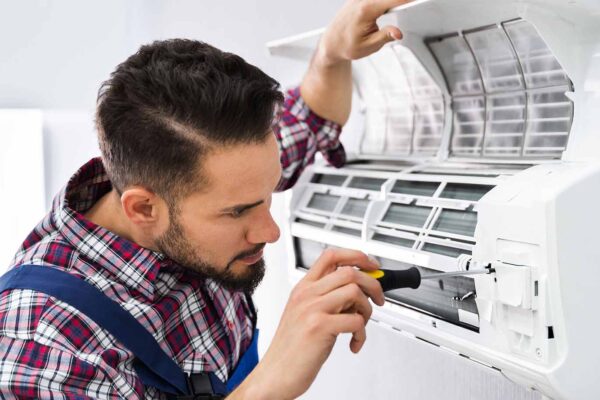 HVAC technician working while Centratel Answering Service manages his client's calls