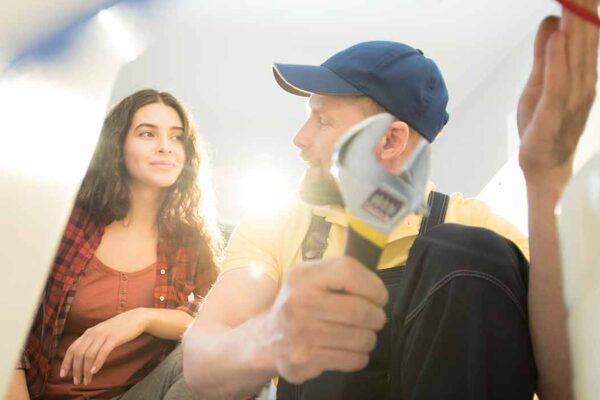 Plumbing business owner taking with the customer helped by a plumbing answering service